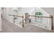 Carpeted loft with wood and white banister overlooking a living area with large windows at 553 Augusta Dr, Canton, GA 30115