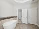 Bright bathroom featuring double sinks, a standalone soaking tub and entry to another room at 553 Augusta Dr, Canton, GA 30115