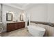 Elegant bathroom featuring double sinks, granite counters, and a standalone soaking tub at 553 Augusta Dr, Canton, GA 30115