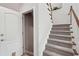 Carpeted staircase featuring wood railing at 553 Augusta Dr, Canton, GA 30115