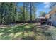 Spacious backyard with mature trees and a patio area, perfect for relaxing and entertaining outdoors at 705 Stewart Nw Cir, Marietta, GA 30064