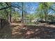 A large backyard, dotted with mature trees, provides ample space and shade for outdoor activities at 705 Stewart Nw Cir, Marietta, GA 30064