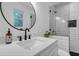 Modern bathroom featuring a white quartz countertop, a round mirror, and a white subway tiled shower at 705 Stewart Nw Cir, Marietta, GA 30064
