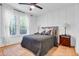 Bright bedroom featuring a bed with board and batten accent wall and natural light from the exterior windows at 705 Stewart Nw Cir, Marietta, GA 30064