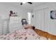 Bedroom featuring hardwood floors, floral bedding, white dressers, and plenty of natural light at 705 Stewart Nw Cir, Marietta, GA 30064