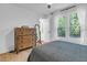 Bedroom filled with natural light and featuring hardwood floors, a window view of the exterior, and a chest of drawers at 705 Stewart Nw Cir, Marietta, GA 30064