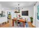 Charming dining room featuring hardwood floors, stylish chandelier and a view into the kitchen at 705 Stewart Nw Cir, Marietta, GA 30064