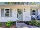 Charming home featuring a light green front door adorned with a wreath and fresh flowers at 705 Stewart Nw Cir, Marietta, GA 30064