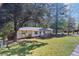 A lush green lawn and mature trees enhance the curb appeal of this charming single story home at 705 Stewart Nw Cir, Marietta, GA 30064