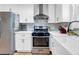 Modern kitchen with white cabinets, stainless steel appliances, and stylish tile backsplash at 705 Stewart Nw Cir, Marietta, GA 30064