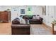 Comfortable living room with a large brown leather sectional and a neutral area rug for a cozy space at 705 Stewart Nw Cir, Marietta, GA 30064