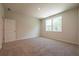 Bright bedroom with carpet, large windows, and a neutral color scheme at 7505 Woolf Way, Cumming, GA 30028
