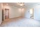 Bright bedroom with neutral carpet, ceiling fan, and access to bath and another room at 7505 Woolf Way, Cumming, GA 30028