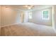 Spacious bedroom with neutral carpet, ceiling fan, and natural light from two windows at 7505 Woolf Way, Cumming, GA 30028