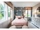 Charming bedroom with a four-poster bed, soft lighting, and decorative wallpaper at 7505 Woolf Way, Cumming, GA 30028