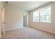 Bedroom with neutral carpet and two large windows for lots of light at 7505 Woolf Way, Cumming, GA 30028