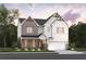 Charming two-story home with brick and white siding, complemented by lush landscaping at 7505 Woolf Way, Cumming, GA 30028