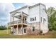 Home exterior featuring a wooden balcony and a brick foundation at 7505 Woolf Way, Cumming, GA 30028