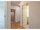 Hallway with hardwood floors leading to bathroom and bedroom at 7505 Woolf Way, Cumming, GA 30028