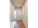 Hallway with wood flooring, white trim, and a glimpse into an adjacent bathroom at 7505 Woolf Way, Cumming, GA 30028