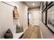 Hallway with bench, pillows, bag and decorative pictures leading to other rooms at 7505 Woolf Way, Cumming, GA 30028