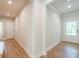 Inviting entry hallway with wood flooring and white trim at 7505 Woolf Way, Cumming, GA 30028