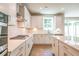 Beautiful white kitchen with stainless steel appliances, quartz countertops, and a gas cooktop at 7505 Woolf Way, Cumming, GA 30028