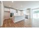 Open concept kitchen with a large island, stainless steel appliances, and access to the backyard via sliding doors at 7505 Woolf Way, Cumming, GA 30028