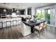 Modern kitchen open to the dining area features sleek black cabinets and a bright breakfast bar at 7505 Woolf Way, Cumming, GA 30028