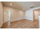 Bright living room features hardwood floors and access to other rooms in the home at 7505 Woolf Way, Cumming, GA 30028