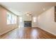 Spacious living room with wood flooring, fireplace, and abundant natural light at 7505 Woolf Way, Cumming, GA 30028