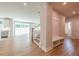 Bright, open-concept living space with wood floors, staircase, and built-in storage at 7505 Woolf Way, Cumming, GA 30028