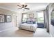 Serene main bedroom features neutral tones, ample natural light and modern accents at 7505 Woolf Way, Cumming, GA 30028