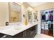 This modern bathroom features double sinks, a vanity and a walk in closet at 1080 Peachtree Ne St # 3213, Atlanta, GA 30309