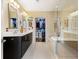 This modern bathroom features a walk in shower, double sinks, and a walk in closet at 1080 Peachtree Ne St # 3213, Atlanta, GA 30309