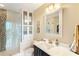 Modern bathroom with a glass-enclosed shower, white countertop, and decorative wall accents at 1080 Peachtree Ne St # 3213, Atlanta, GA 30309