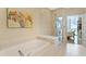 The modern bathroom features a soaking tub, glass enclosed shower and city views at 1080 Peachtree Ne St # 3213, Atlanta, GA 30309