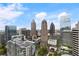 Expansive skyline view showcasing prominent skyscrapers against a blue sky with scattered clouds at 1080 Peachtree Ne St # 3213, Atlanta, GA 30309