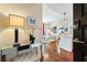 Inviting entryway featuring a mirrored console table, elegant lamp, fresh flowers, and a glimpse into the stylishly decorated living area at 1080 Peachtree Ne St # 3213, Atlanta, GA 30309