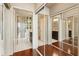 Hallway featuring a bathroom and a closet with mirrored doors and hardwood floors at 1080 Peachtree Ne St # 3213, Atlanta, GA 30309