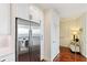 Hallway features a stainless steel refrigerator, hard wood floors, and white doors at 1080 Peachtree Ne St # 3213, Atlanta, GA 30309