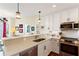 Bright kitchen features stainless appliances, white cabinetry and stone countertops in this modern home at 1080 Peachtree Ne St # 3213, Atlanta, GA 30309