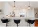 Modern kitchen with sleek white cabinets, stainless steel appliances, a breakfast bar, and stylish pendant lighting at 1080 Peachtree Ne St # 3213, Atlanta, GA 30309