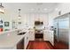 Bright kitchen features stainless appliances, white cabinetry and an ornate rug in this modern home at 1080 Peachtree Ne St # 3213, Atlanta, GA 30309