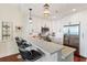 Contemporary kitchen with white cabinetry, stainless steel appliances, a breakfast bar, and elegant pendant lights at 1080 Peachtree Ne St # 3213, Atlanta, GA 30309