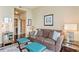 Neutral living room with stylish furniture, including a sofa with throw pillows and two ottomans at 1080 Peachtree Ne St # 3213, Atlanta, GA 30309