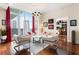 Bright living room with floor-to-ceiling windows, hardwood floors, comfortable seating, and cityscape views at 1080 Peachtree Ne St # 3213, Atlanta, GA 30309