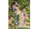 Aerial view of a new construction neighborhood with tree-lined streets and custom homes at 115 Nova Ln, Roswell, GA 30075