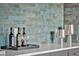 Close up of the bar with wine bottles, wine glasses, and silver accent pieces at 115 Nova Ln, Roswell, GA 30075