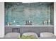 Bar area with blue textured tile, wine bottles, glasses, and gray shaker cabinets at 115 Nova Ln, Roswell, GA 30075
